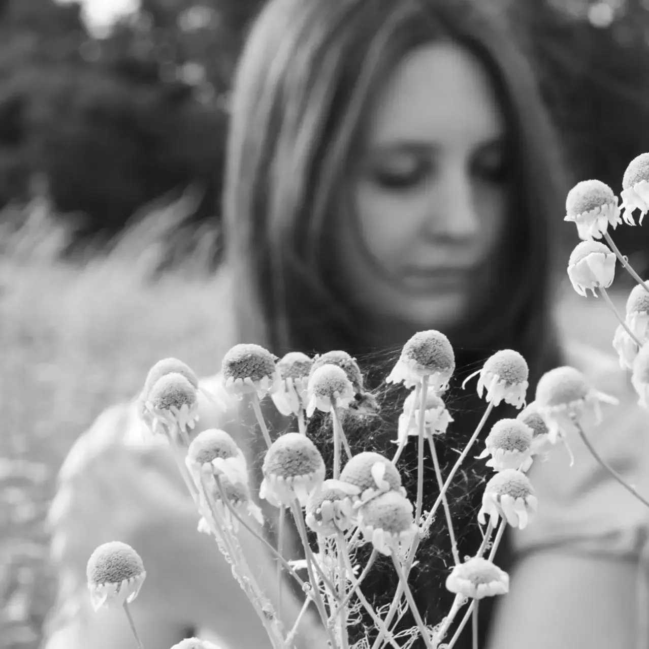 Black-and-white portrait of Marie Schmidhuber among flowers
